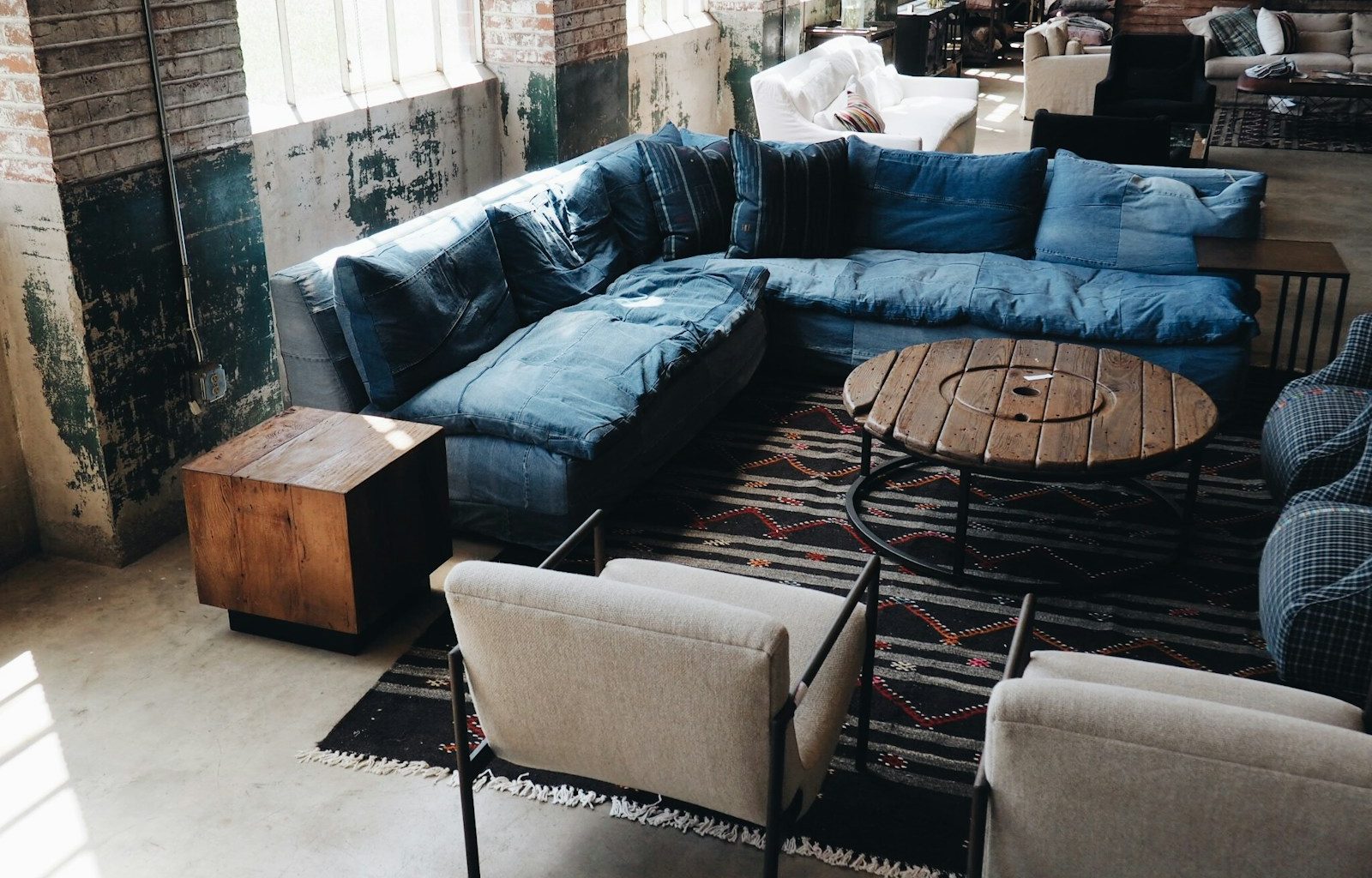 blue couch and white armchairs